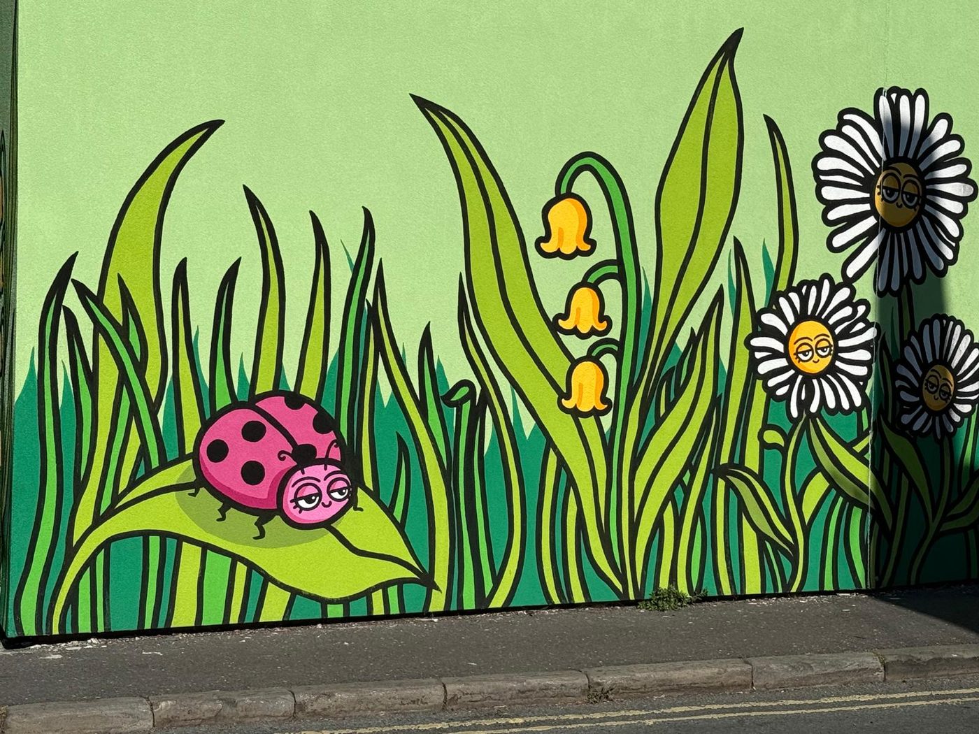 A colourful naturalistic mural on a Bristol wall.