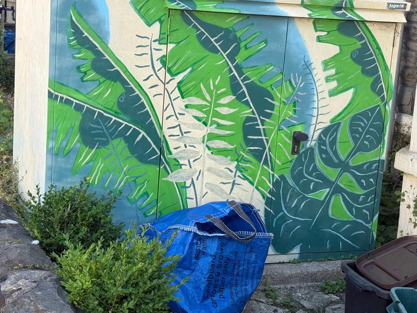 A brightly painted bike store shed.